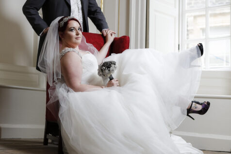 Bride and groom lounging in an elegant Georgian room