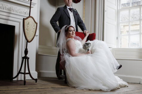 Bride and groom lounging in an elegant Georgian room