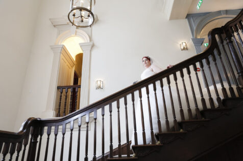 bride coming down the stairs of an elegant Georgian House